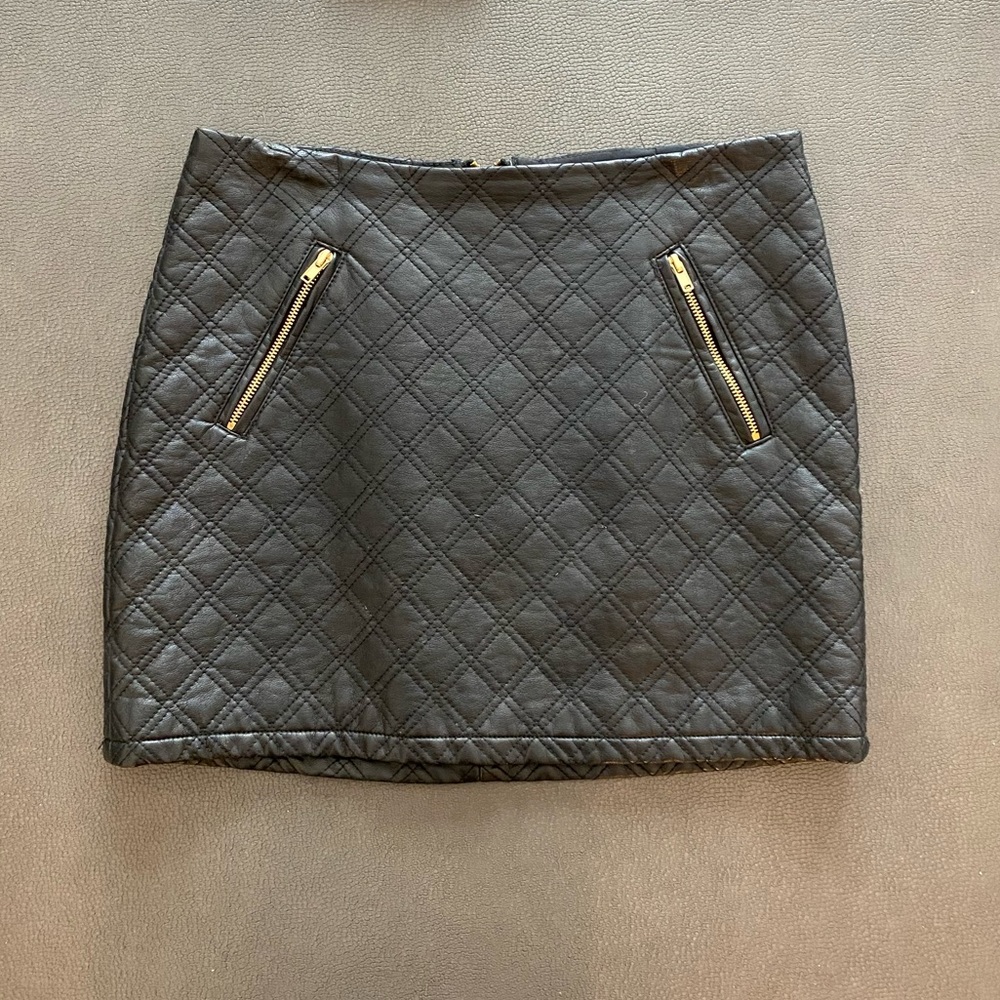 Black leather skirt with gold zippers